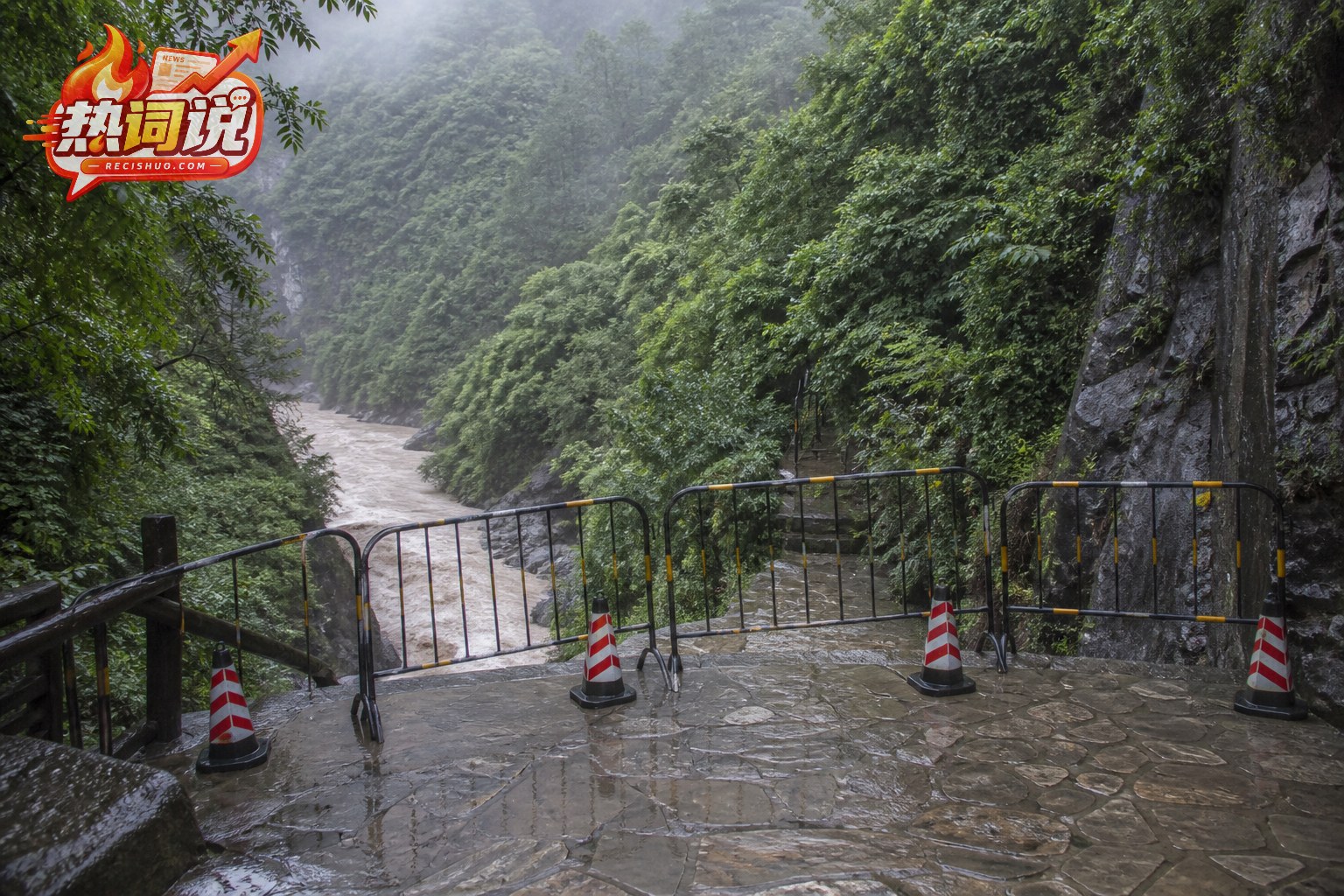 雨中山区峡谷步道被护栏封闭且河流水位明显上涨