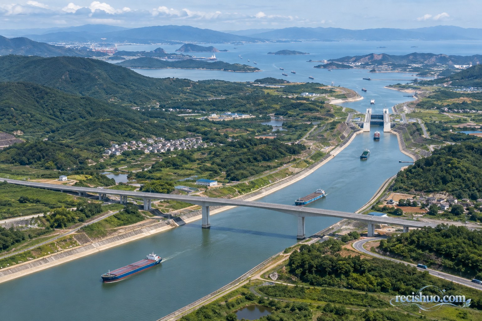 运河穿过丘陵并向远处海湾延伸的航运场景示意图