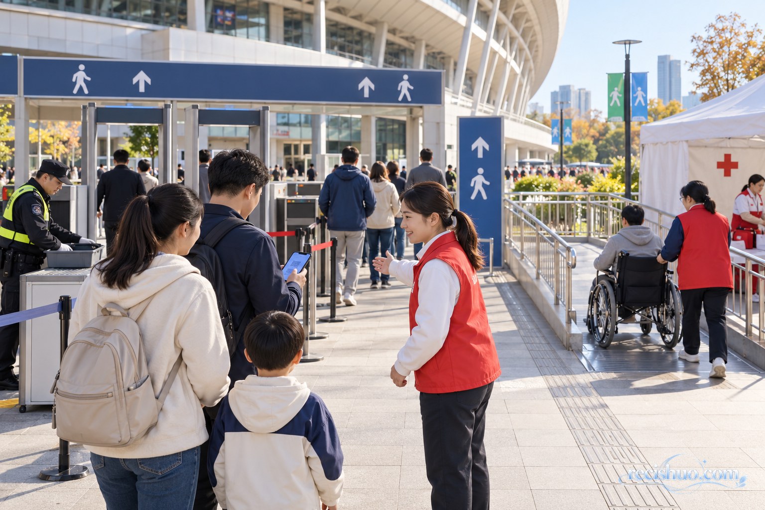 体育馆入口处志愿者引导家庭观众安检入场并提供无障碍服务的场景