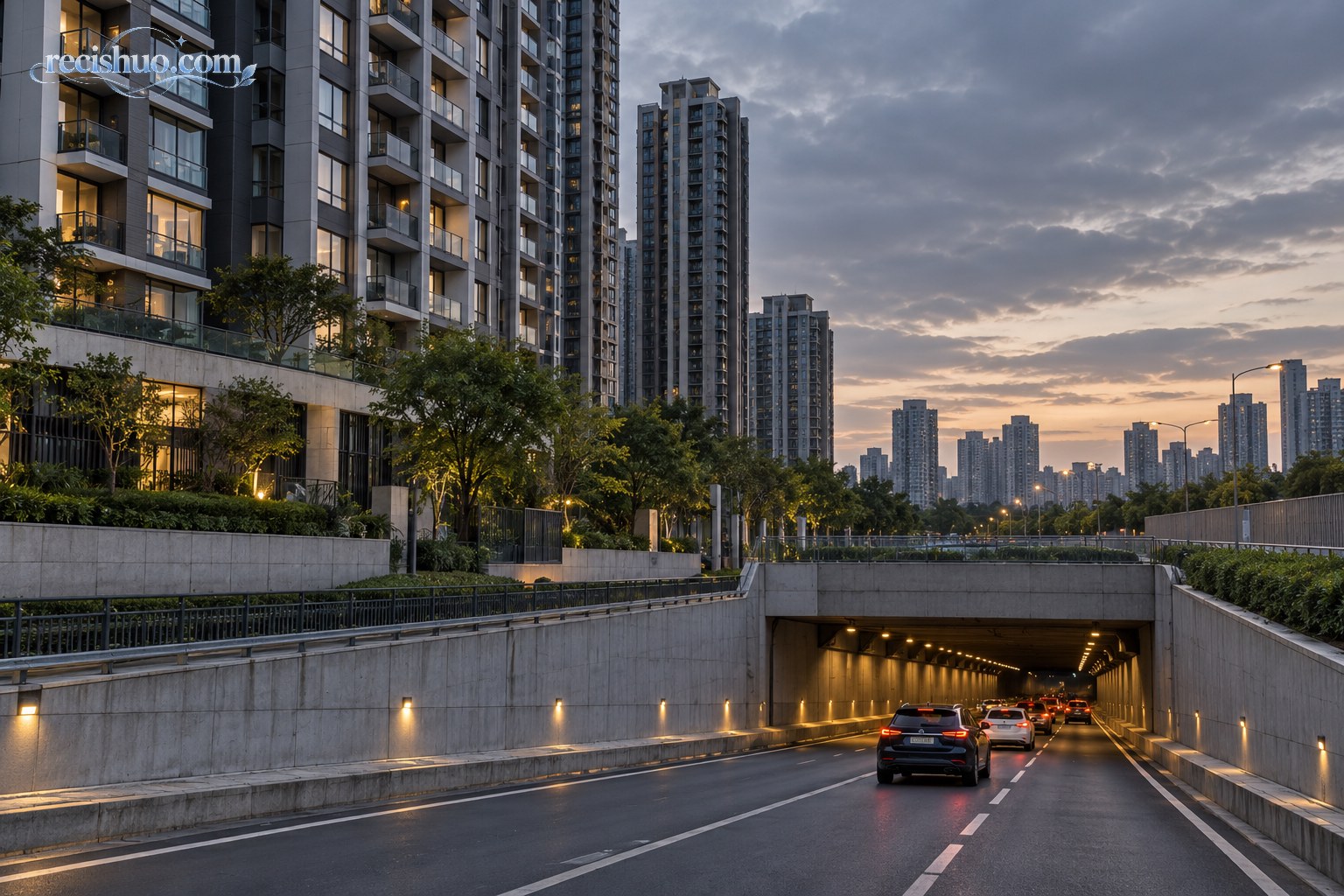 傍晚城市住宅楼旁车辆驶入地下隧道的道路场景